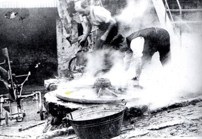 Father Fred Walter (without cap) working at the Old Forge Widecombe in 1920s (Photo from Steven Woods' book 'Widecombe in the Moor')